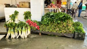 A variety of fresh vegetables on display at an outdoor market stall in Mingora, Pakistan.